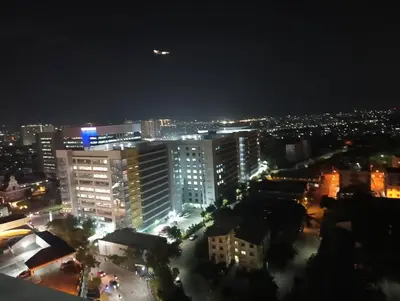 a view of a city at night with lights at Cozy condo with balcony in Taguig in Manila