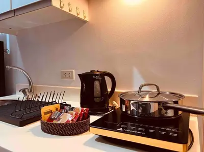 a stove top with a tea pot and a basket of food at Relaxing 1-Bedroom Unit in Azure Urban Resort and Residences by One Guest Place in Manila