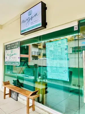 a bench sitting in front of a store window at Richjones Bed & Breakfast in Manila