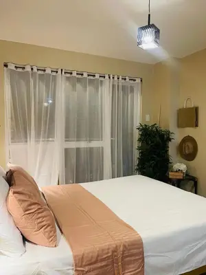 a bedroom with a large bed and a window at Richjones Bed & Breakfast in Manila