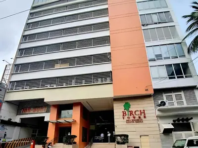 a building with the front of the branch at Birch Tower in Manila