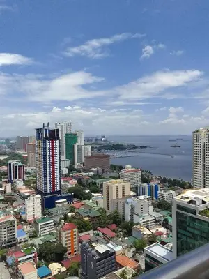 a view of a city with buildings and a body of water at Birch Tower in Manila