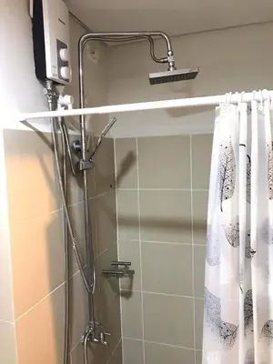a shower in a bathroom with a shower curtain at LJ'S Escape 1BR Coast Residences in Manila