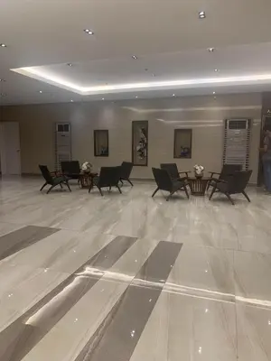 a large room with chairs and tables in a building at LJ'S Escape 1BR Coast Residences in Manila