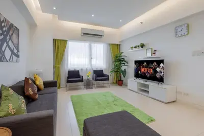 a living room with a couch and a flat screen tv at NEW 2BR of 86sqm with Parking & Netflix in BGC in Manila