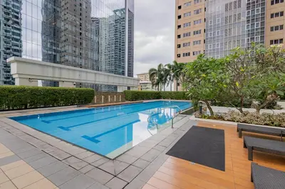 a swimming pool in a city with tall buildings at NEW 2BR of 86sqm with Parking & Netflix in BGC in Manila