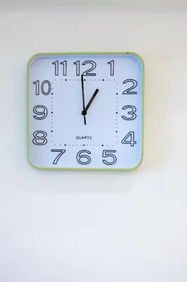 a white clock on a white wall at NEW 2BR of 86sqm with Parking & Netflix in BGC in Manila