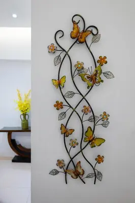 a metal butterfly wall art on a wall at NEW 2BR of 86sqm with Parking & Netflix in BGC in Manila