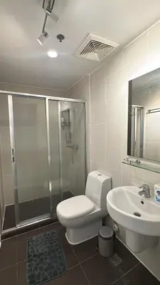 a bathroom with a toilet and a shower and a sink at KL Rooms at Greenbelt makati with cityview in Manila