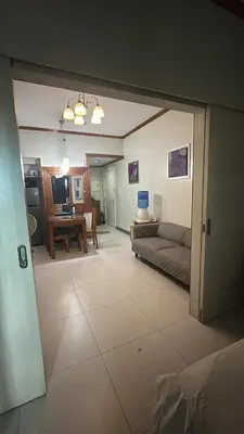a living room with a couch and a table at KL Rooms at Greenbelt makati with cityview in Manila