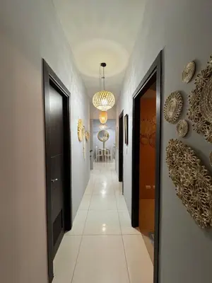 a hallway with black doors and white tile floors at Glamorous 3BR Suite in Uptown BGC w/Bathtub in Manila