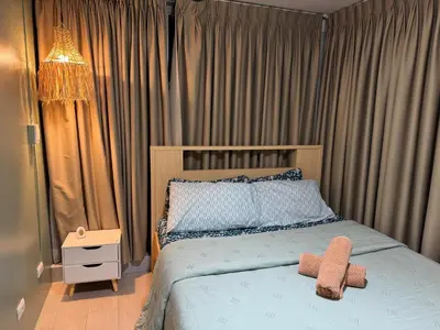 a bedroom with a bed with a teddy bear on it at Glamorous 3BR Suite in Uptown BGC w/Bathtub in Manila