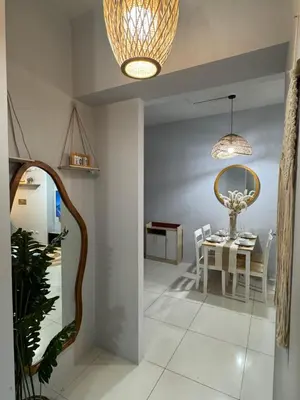 a dining room with a table and a chandelier at Glamorous 3BR Suite in Uptown BGC w/Bathtub in Manila