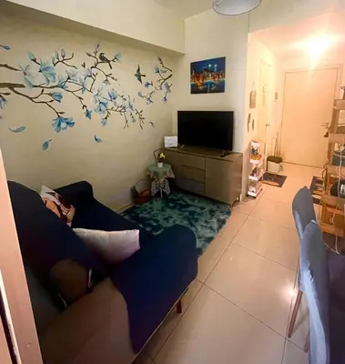 a living room with a couch and a tv at Condo with Balcony at Makati SM Jazz in Manila