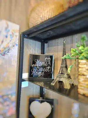 a shelf with a picture of the words home sweet home at Cozy Comfy Suite 2BR w Balcony - Amazing Manila Bay View and City Skyline near MOA in Manila