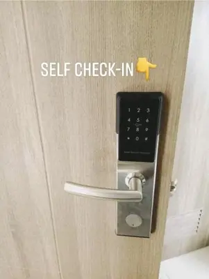 a door with a self check in sign on it at Cozy Comfy Suite 2BR w Balcony - Amazing Manila Bay View and City Skyline near MOA in Manila