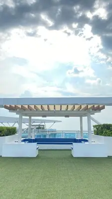 a large white bench sitting on top of a field at Azure Urban Beach Resort Residences in Manila