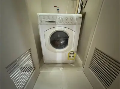 a washer and dryer in a small room at Modish 1BR One Uptown BGC direct to Uptown Mall in Manila