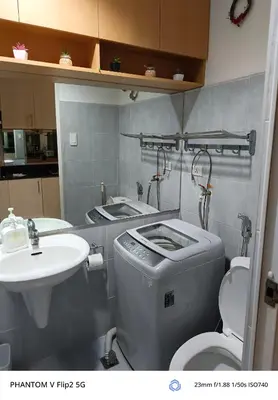 a bathroom with a toilet and a sink at Sea Residence Finest in Manila