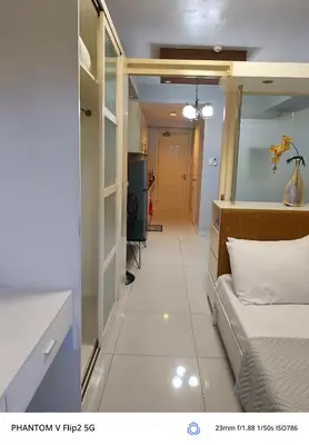 a room with a bed and a hallway at Sea Residence Finest in Manila