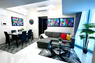 a living room with a couch and a table at Cozy 2 Bedrooms in BGC with Balcony Bathtub 600Mbps in Manila