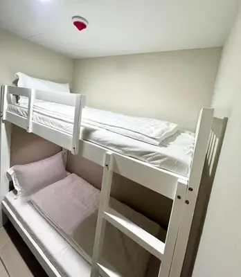 a small room with two bunk beds in it at Cozy 2 Bedrooms in BGC with Balcony Bathtub 600Mbps in Manila