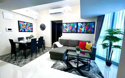 a living room with a couch and a table at Cozy 2 Bedrooms in BGC with Balcony Bathtub 600Mbps in Manila