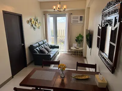 a living room with a table and a couch at The Verdin at Maple Grove in Cavite