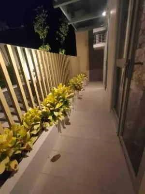 a hallway with yellow flowers on a fence at The Verdin at Maple Grove in Cavite