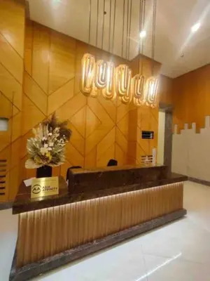 a lobby with a counter with flowers on it at The Verdin at Maple Grove in Cavite