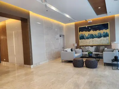 a lobby with a couch and chairs and a painting at SMDC Shore 3 Residences - One Bedroom Unit in Manila