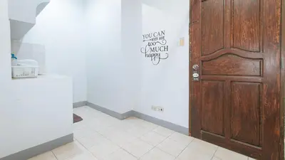 a room with a door with a sign on the wall at MCP Transient near NAIA in Manila