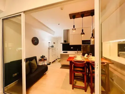 a kitchen and living room with a table and chairs at Manila Philippines, Azure Urban Resort Staycation by Leroche near Ninoy Aquino International Airport in Manila