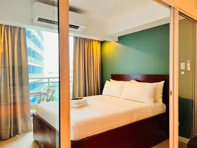 a bedroom with a bed with a glass wall at Manila Philippines, Azure Urban Resort Staycation by Leroche near Ninoy Aquino International Airport in Manila