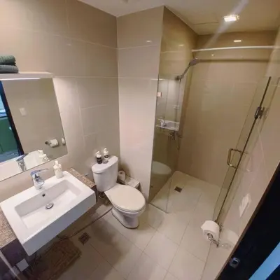 a bathroom with a toilet and a sink and a shower at -CONDO- Petite Residential Stay in Manila