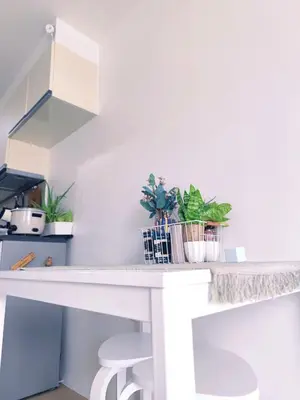 a white kitchen counter with plants on it at -CONDO- Petite Residential Stay in Manila