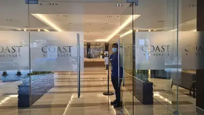 a woman wearing a mask in a store window at Cozy Penthouse 2BR Suite w Balcony - Amazing Manila Bay View and City Skyline near MOA in Manila
