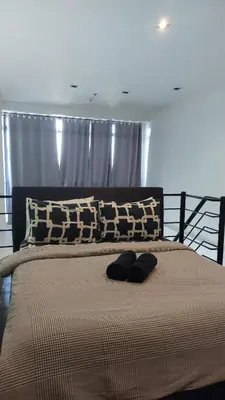 a bed with two pillows on top of it at Homestead in Manila