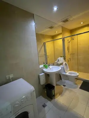 a bathroom with a sink and a toilet and a shower at Homestead in Manila