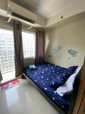 a bedroom with a bed with stars on the wall at Shell Residence Moa - Anne in Manila