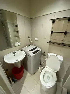 a small bathroom with a toilet and a sink at Shell Residence Moa - Anne in Manila