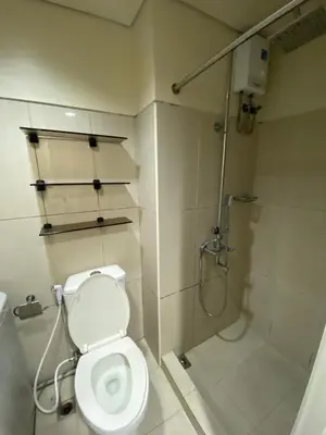 a bathroom with a toilet and a shower at Shell Residence Moa - Anne in Manila
