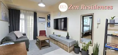 a living room with a couch and a tv at Bliss by Zen Residences at The Radiance Manila Bay in Manila