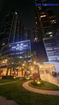 a building with writing on it in a city at night at Bliss by Zen Residences at The Radiance Manila Bay in Manila
