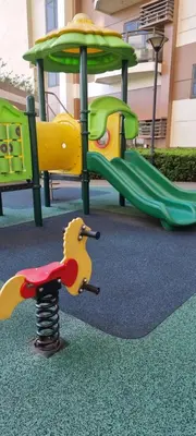 a playground with two play equipment in a park at Bliss by Zen Residences at The Radiance Manila Bay in Manila