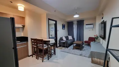 a small living room with a couch and a table at Bliss by Zen Residences at The Radiance Manila Bay in Manila