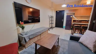 a living room with a couch and a table at Bliss by Zen Residences at The Radiance Manila Bay in Manila
