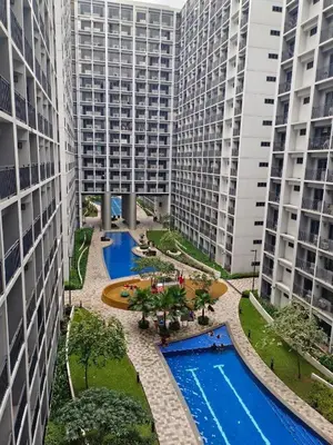 an aerial view of two tall buildings with two pools at Cozy Condo near Mall of Asia in Manila