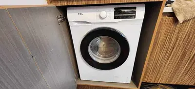 a washer and dryer in a wooden box at Cozy Studio Unit near Manila Airport With Swimming Pool, Full Kitchen 7A in Manila