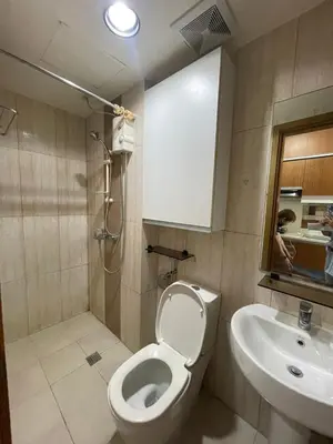 a bathroom with a toilet and a sink at Modern Bayview Condo in 8 Adriatico in Manila